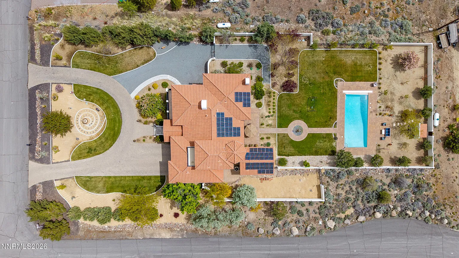 The lot from directly above: house, solar roof, lawn and pool