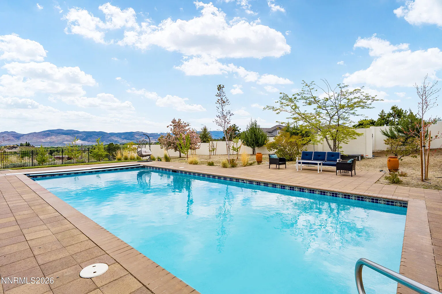 Backyard pool with the house behind it