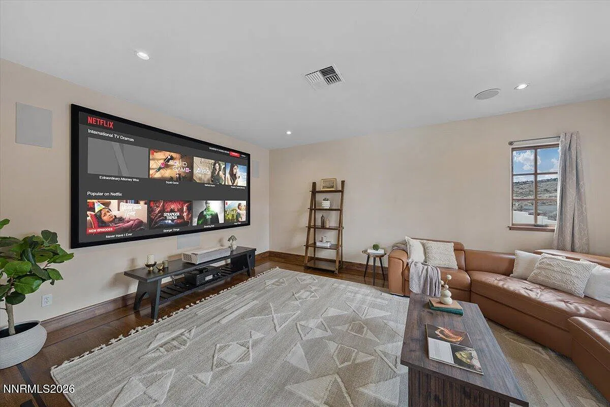 Theatre room with a large screen and leather sectional